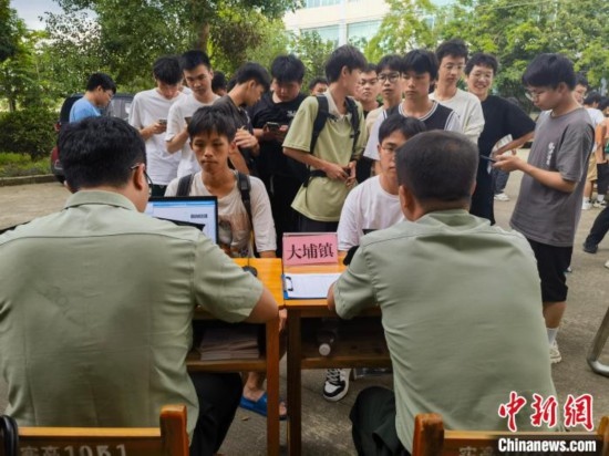 專武干部在發(fā)放兵役登記證。韋碩 攝