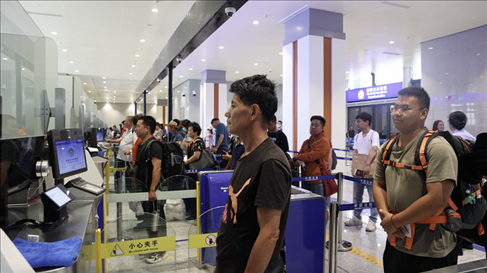 6月13日，乘坐中老鐵路國際旅客列車的旅客在磨憨邊檢大廳排隊(duì)候檢。李揚(yáng) 攝