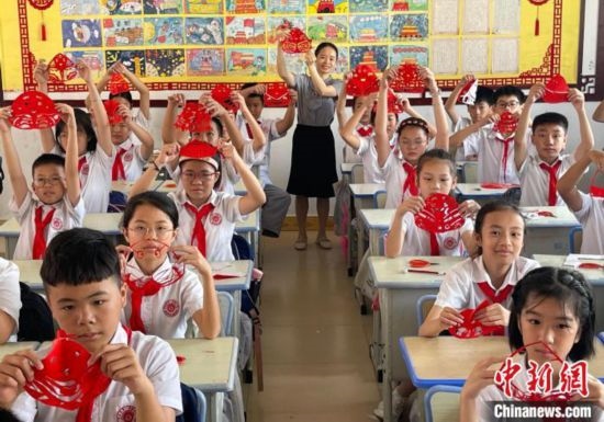 圖為學生們展示剪紙作品。 興業(yè)縣融媒體中心供圖