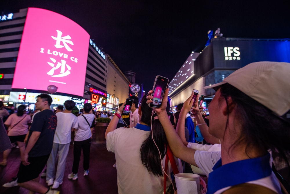  游客在長(zhǎng)沙市天心區(qū)黃興路步行街打卡、拍照（6月7日攝）。新華社記者 陳思汗 攝