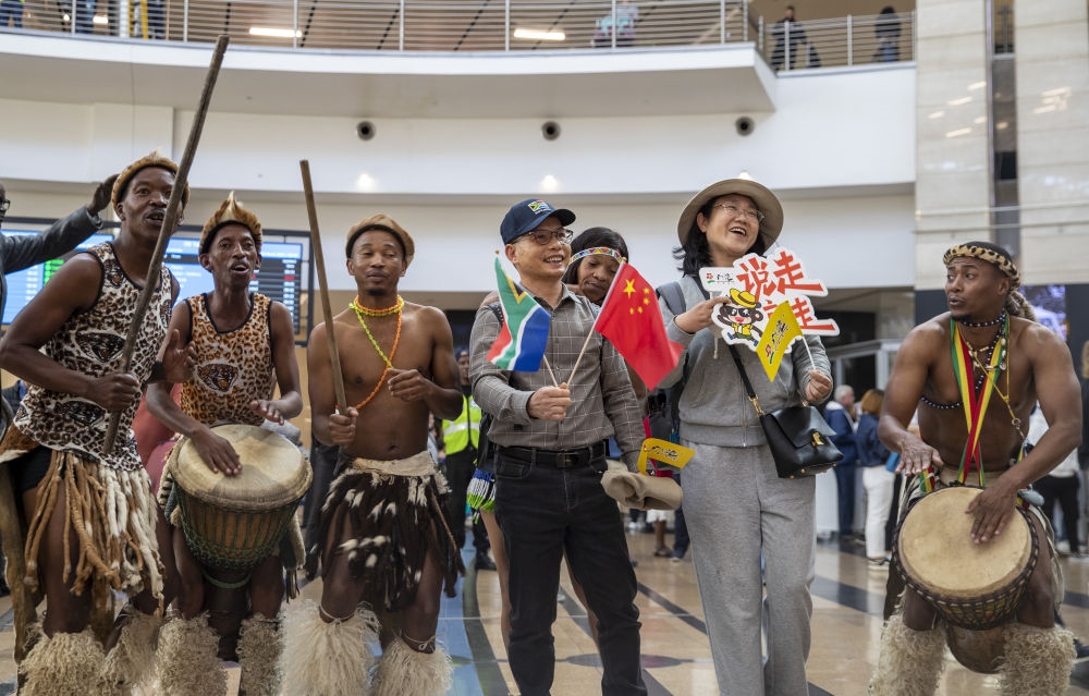 在南非約翰內(nèi)斯堡坦博國際機(jī)場，南非舞蹈演員歡迎中國試點(diǎn)恢復(fù)出境團(tuán)隊(duì)旅游后首批抵達(dá)南非的中國游客（2023年3月29日攝）。