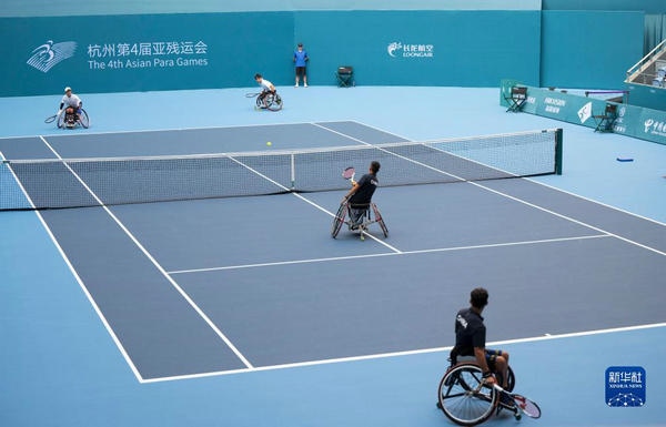 10月24日，在杭州第4屆亞殘運(yùn)會(huì)輪椅網(wǎng)球男子雙打1/4決賽中，中國(guó)組合董順江/紀(jì)珍旭以0比2不敵韓國(guó)組合任浩元/韓成奉，無(wú)緣半決賽。圖為董順江（右二）/紀(jì)珍旭（右一）在比賽中。新華社記者 才揚(yáng)攝