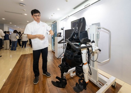 2024年5月24日，在位于上海市嘉定區(qū)的上海交通大學(xué)醫(yī)學(xué)院附屬瑞金醫(yī)院腫瘤質(zhì)子中心，工作人員介紹由瑞金醫(yī)院醫(yī)生和醫(yī)療公司共同研發(fā)的用于恢復(fù)患者下肢的醫(yī)療機(jī)器人。新華社記者 王翔 攝