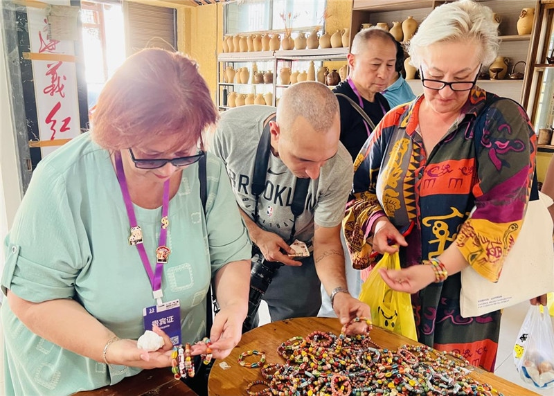 歐亞媒體考察團成員在母氏陶藝館內挑花了眼，色彩絢麗、質地均勻的陶藝手串讓他們愛不釋手?！斑@里的東西都太實惠了！”塔吉克斯坦《索格特真理報》政論部主任娜塔利婭·多羅費耶娃說?；宓奶厣a(chǎn)品物美價廉，讓考察團成員為家人好友買到了心儀的禮物，也為此次以四川成都為起點，路經(jīng)南充、廣安至貴州遵義的考察行程畫上了圓滿句號。（張亞欣攝）