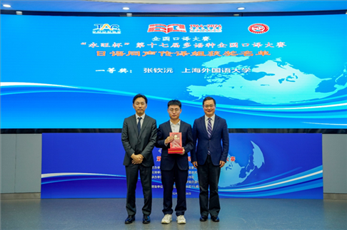 北京第二外國語學院副院長鄭承軍（右一）、永旺中國投資有限公司集團管理總部總經(jīng)理稻垣浩司（左一）為獲得日語同傳組一等獎的上海外國語大學的張欽沅頒獎。主辦方供圖