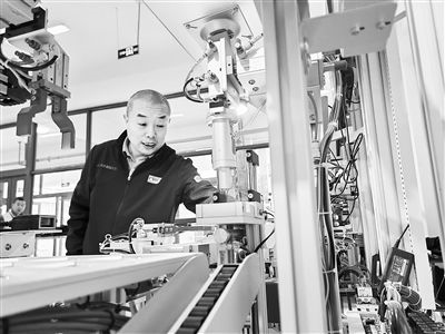 郭海青在檢查車床加工設(shè)備。 受訪者供圖