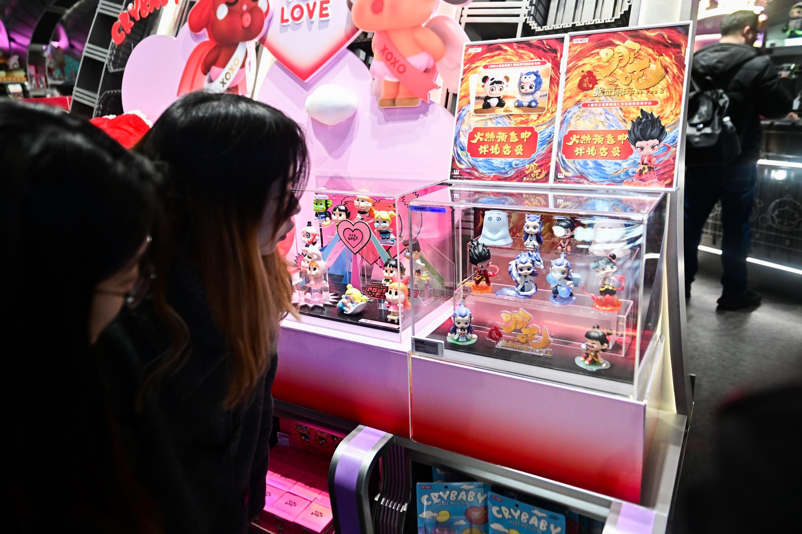 △2025年2月22日，上海，市民在圍觀《哪吒之魔童鬧?！废嚓P(guān)手辦盲盒。